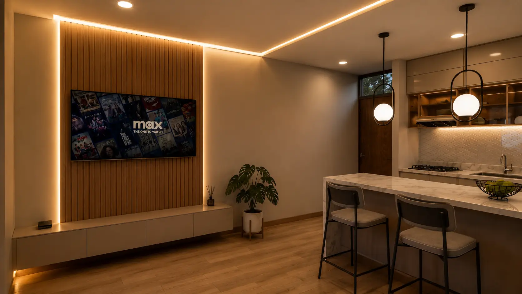 Sala con televisor y barra de cocina al fondo